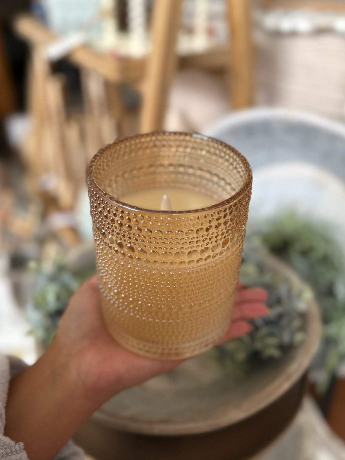 Champagne dotted glass flameless candle with raised texture and flickering 3D flame