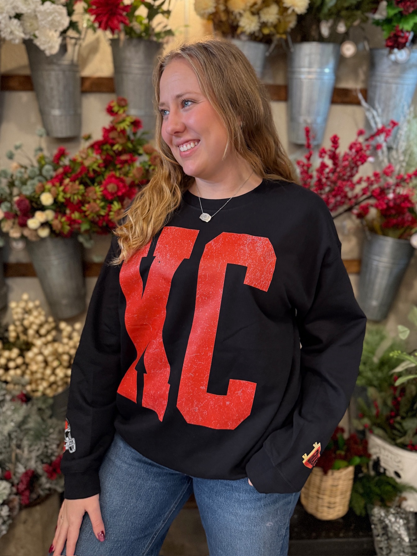KC crewneck displayed on model with oversized varsity-style KC lettering and relaxed fit.