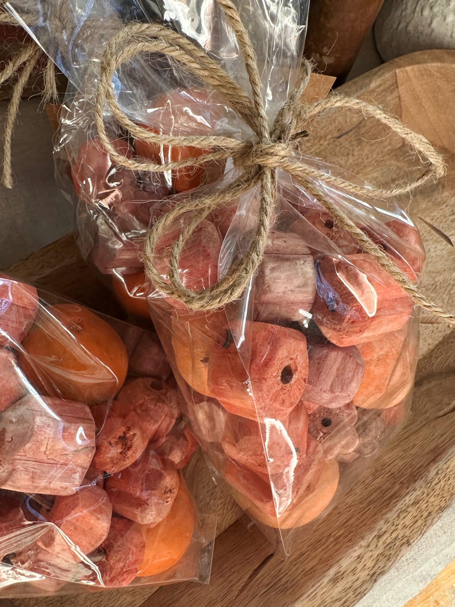 Bag of Pumpkin Shaped Mix Bowl Filler tied with twine, featuring dried natural orange-toned pieces.
