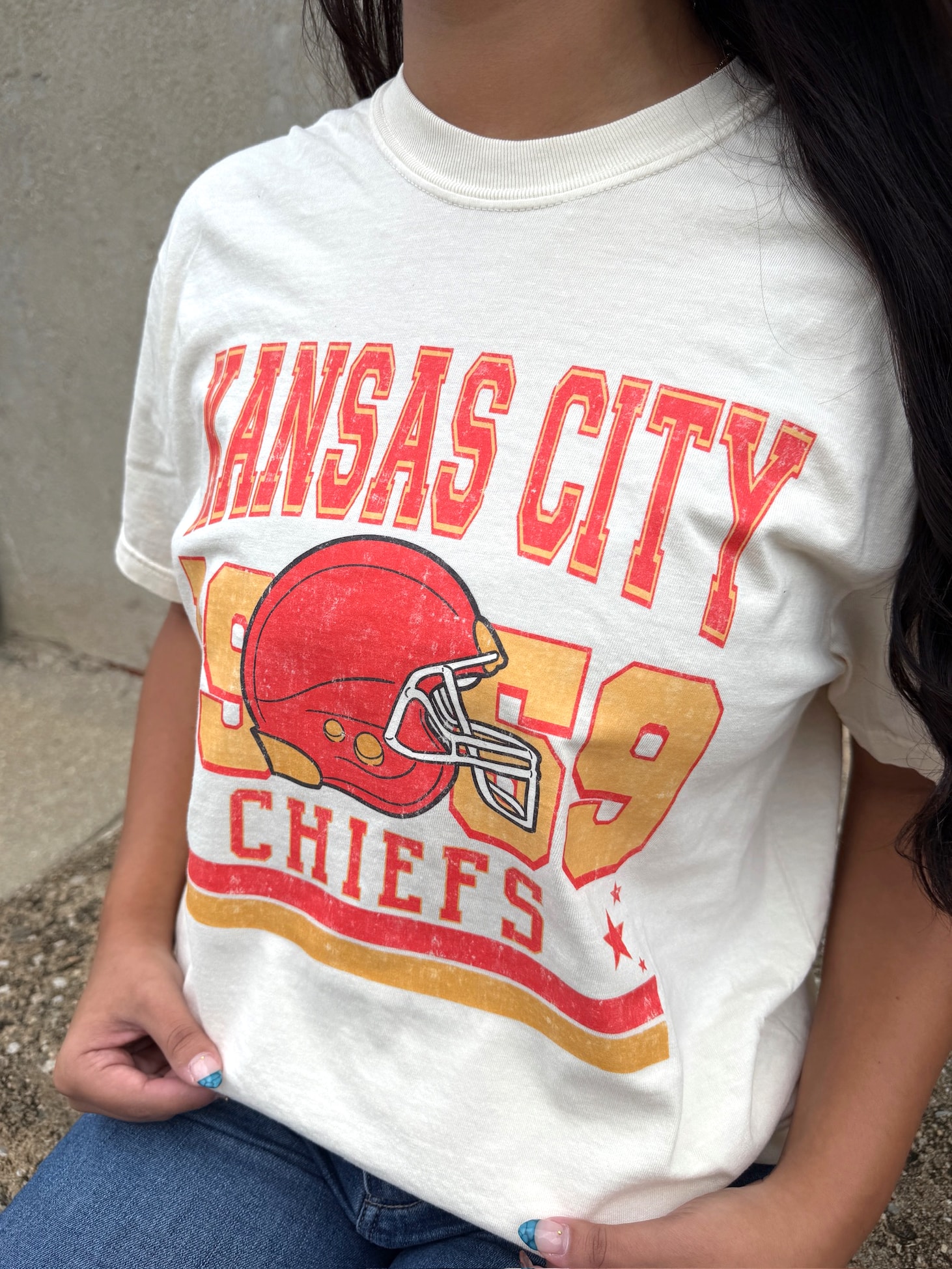 Close-up of Kansas City Chiefs vintage helmet and 1969 lettering on ivory tee.