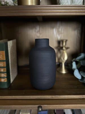 The Textured Vase Oblong – Small styled on a wooden bookshelf with decor accents, highlighting its minimal yet bold design.