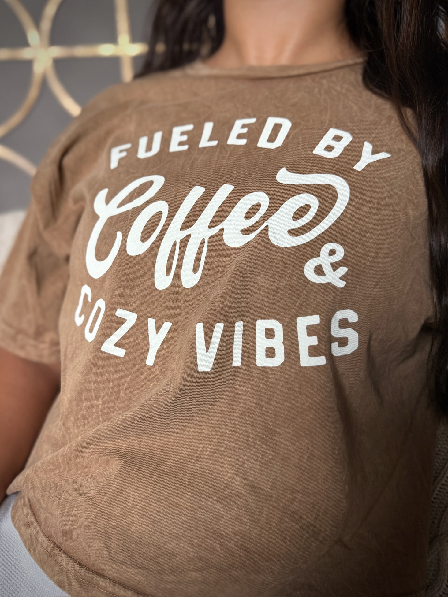 Relaxed fit crop tee in tan with “Fueled by Coffee & Cozy Vibes” print.