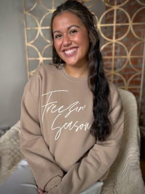 Cozy tan fleece crewneck with Freezin’ Season graphic, styled for chilly days