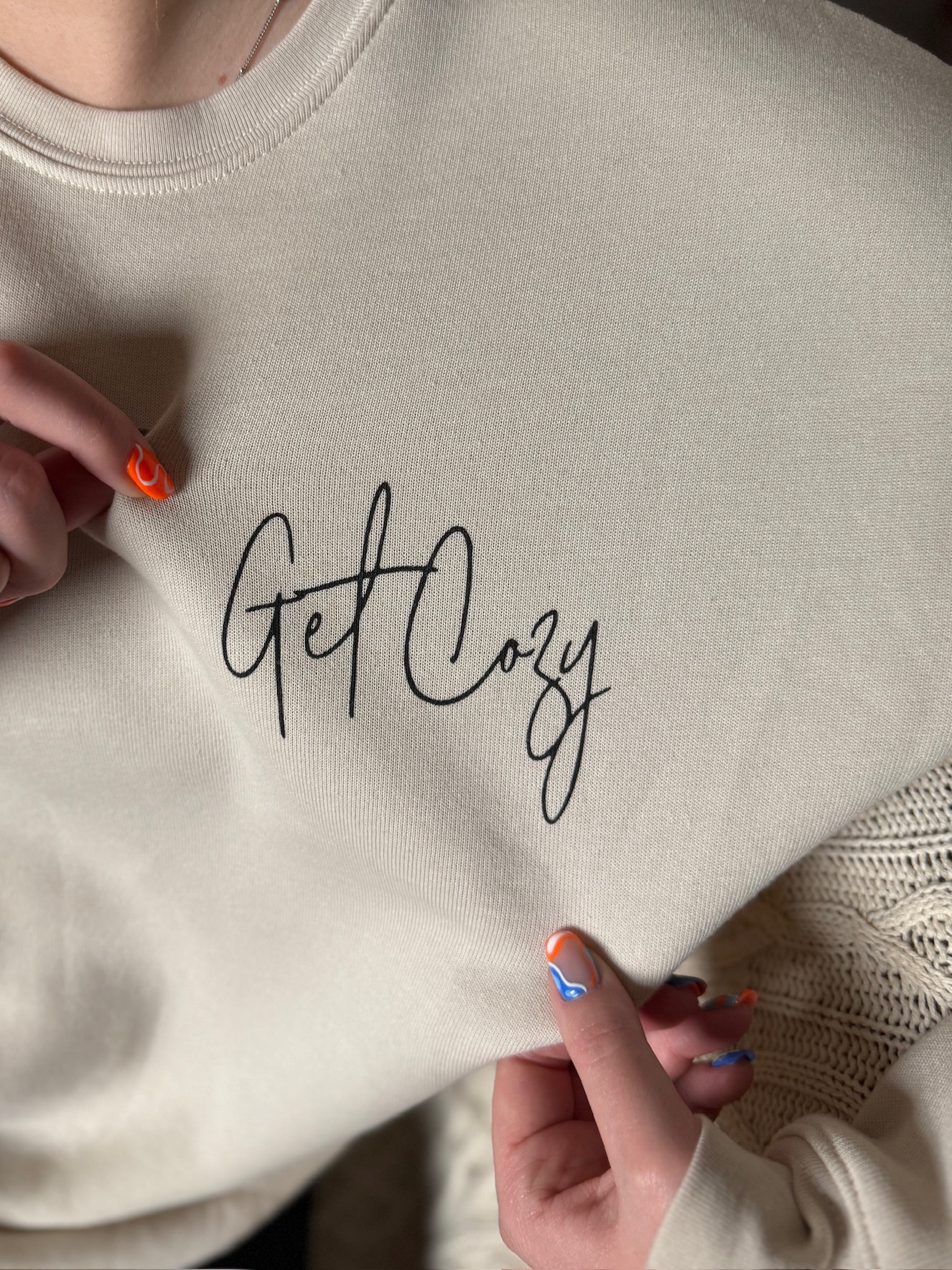 Heather dust sweatshirt featuring simple cursive “Get Cozy” graphic.