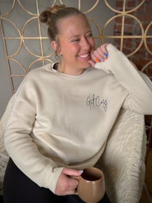 Unisex fleece crewneck in light heather dust with minimalist “Get Cozy” design.