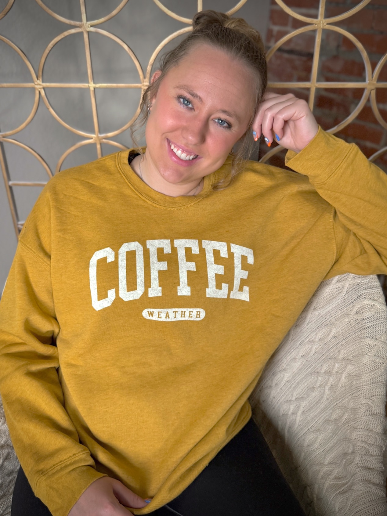 Mustard yellow pullover sweatshirt featuring coffee-themed graphic โCOFFEE WEATHER.โ