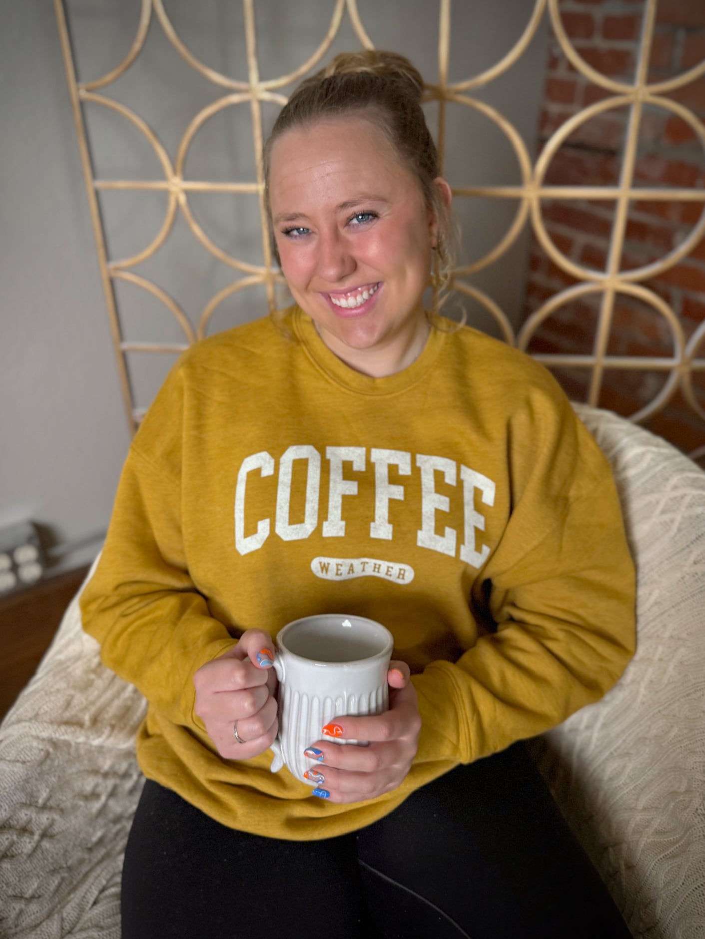 be-made-hays-ks-coffee-weather-sweatshirt-heather-mustard Unisex fleece crewneck in mustard with collegiate-style โCOFFEE WEATHERโ text.