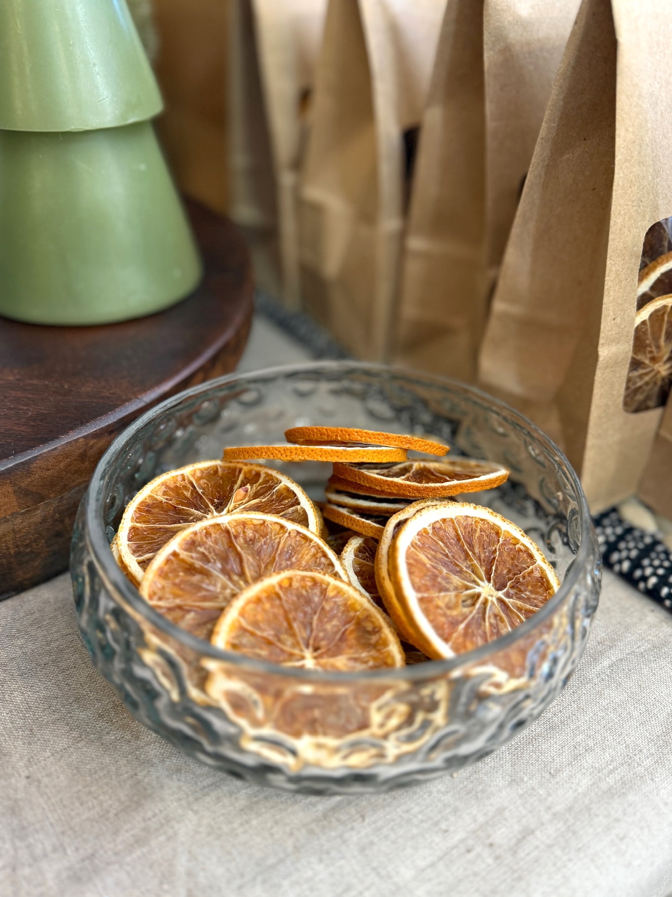 be-made-hays-ks-dried-oranges-in-hobnail-bowl Hand-blown hobnail glass bowl displaying dried orange slices with warm, natural décor behind it.