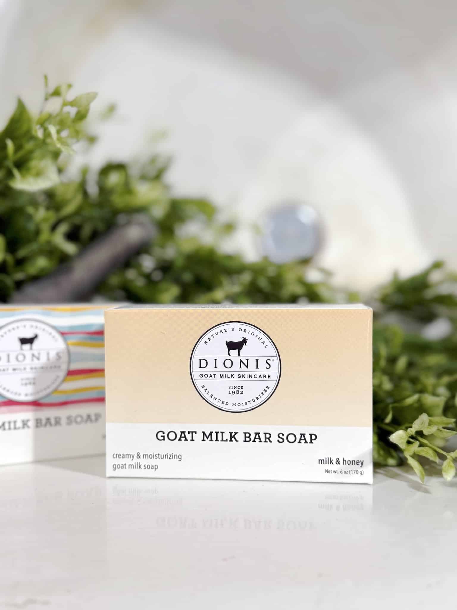 Milk & Honey Goat Milk Soap box shown sideways in front of a leafy display and farmhouse sink.