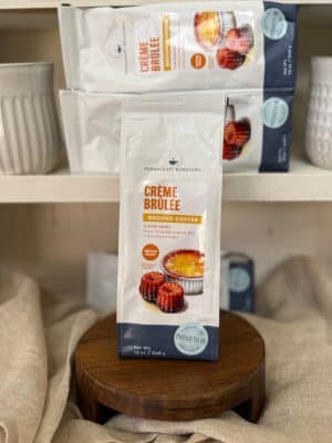 Close-up of Crème Brûlée ground coffee packaging with vanilla custard and caramelized sugar flavor notes.