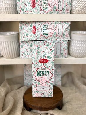 Holiday-themed White Mocha Latte medium roast ground coffee on display shelf.