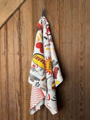 Double-sided KC Chiefs Icon Tea Towel with bold red and yellow doodle graphics and “Touchdown” text, shown hanging against a rustic wood background.