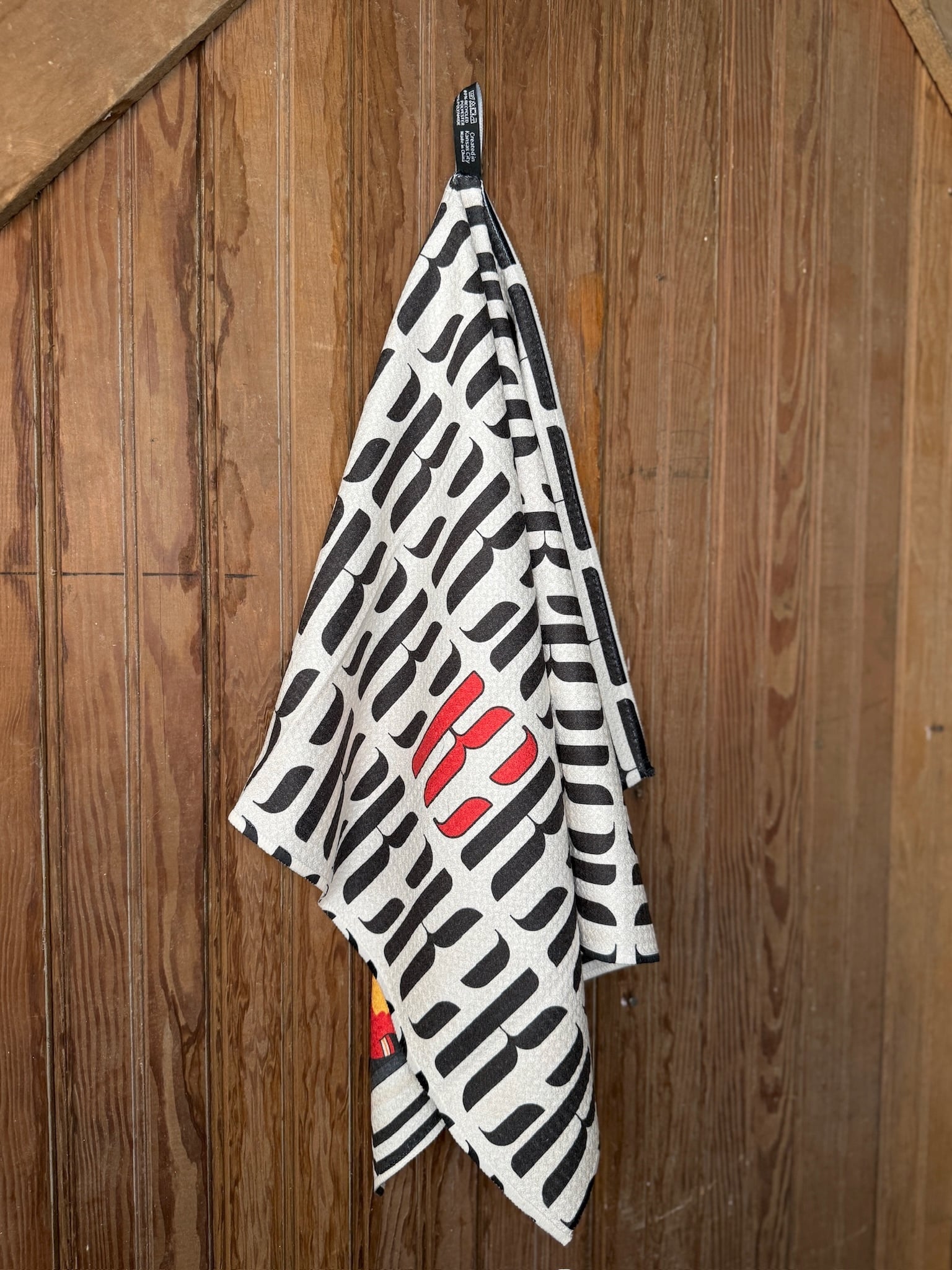 Microfiber KC Chiefs Tea Towel with red and white football jersey designs on one side and bold black-and-gold KC pattern on the reverse, shown flat and hanging.