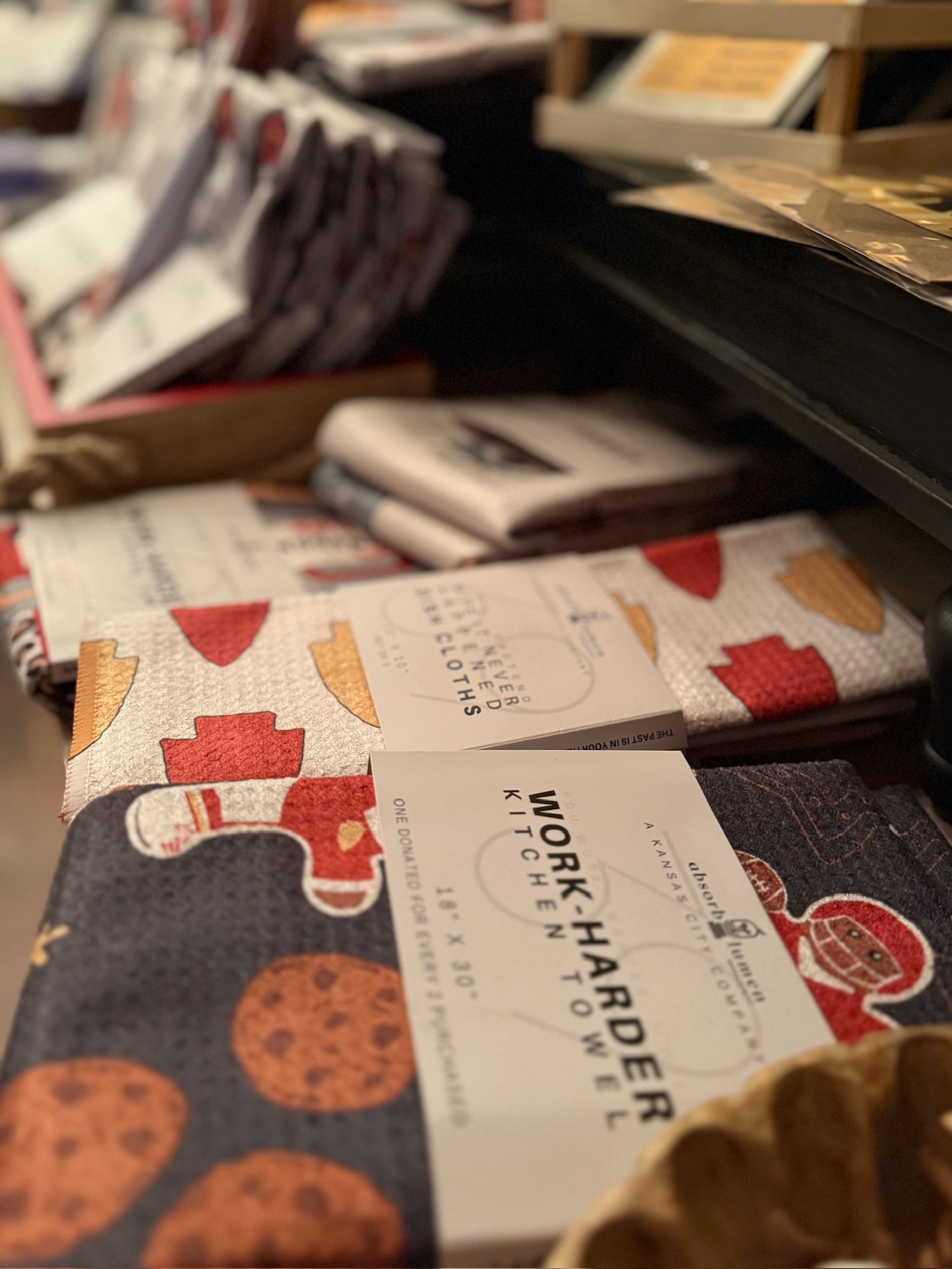 Chiefs Arrowhead Double-Sided Dish Cloth Set displayed on a table, featuring red and gold game-day patterns with durable microfiber packaging labeled “Work Harder Kitchen Towel.”