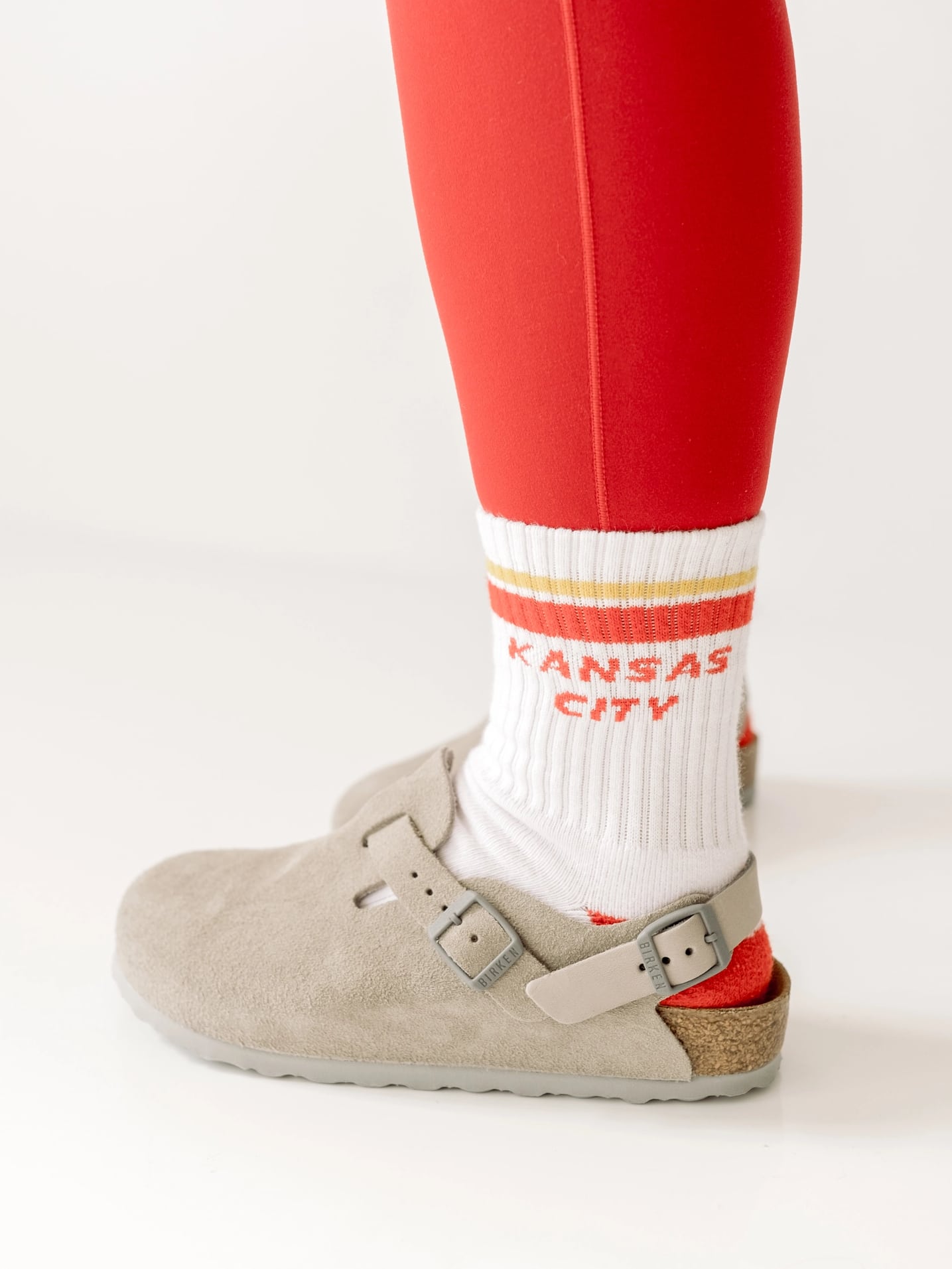 White Kansas City crew socks styled with red leggings and casual shoes
