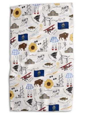 Kansas Icons Tea Towel with playful illustrations of state favorites including sunflowers, barns, buffalo, windmills, bass, and ruby slippers.