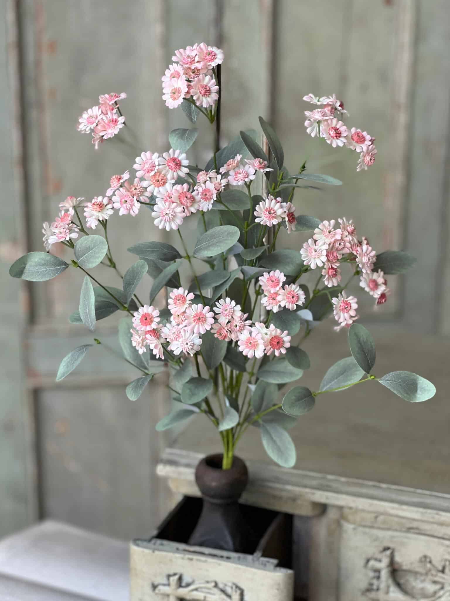 Soft Pink Daisy Bush arranged in a vase for airy height and natural movement.