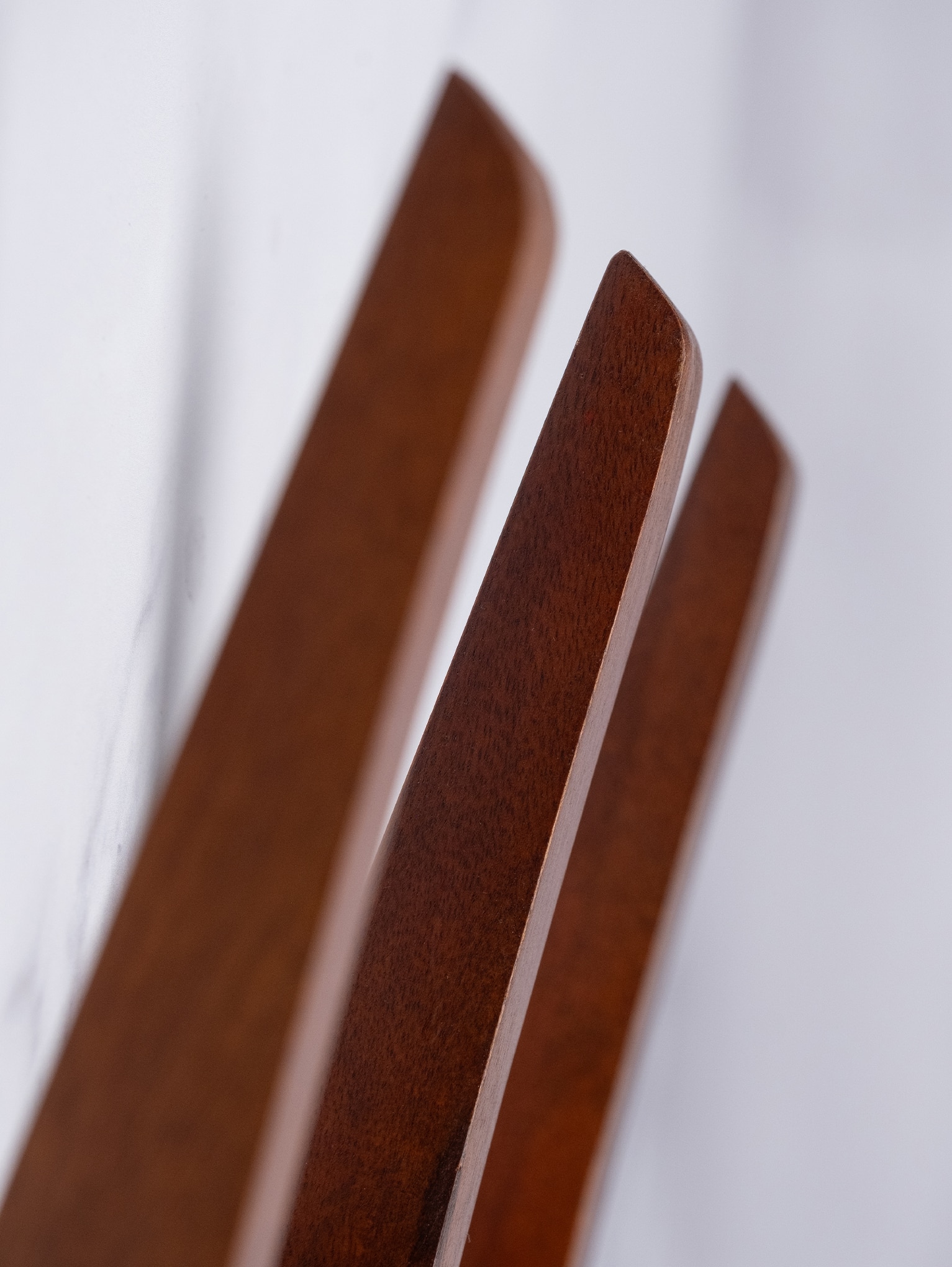 Close-up of curved wood pegs on the Wood Hanging Wall Rack showing smooth edges and rich grain detail.