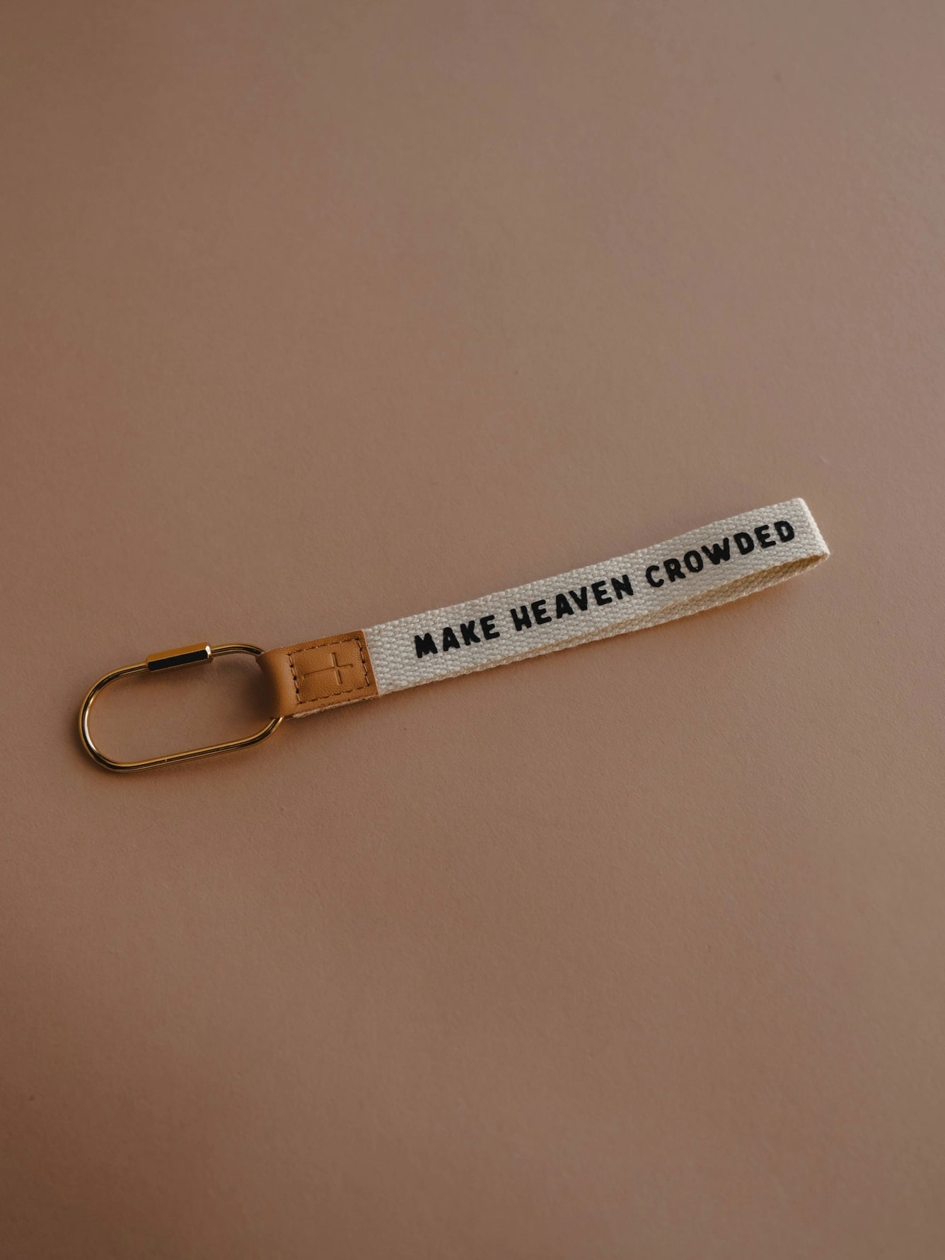 be-made-hays-ks-faith-inspired-make-heaven-crowded-wristlet-keychain Fabric wristlet keychain reading “Make Heaven Crowded,” featuring a leather cross tag and sturdy gold carabiner.