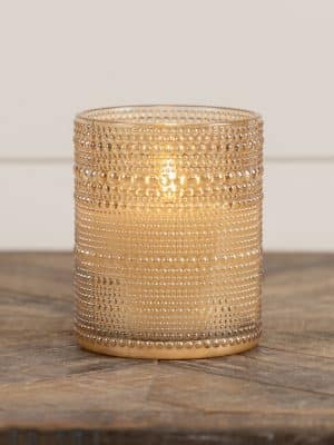 Elegant champagne flameless candle in dotted glass with 3D flame.