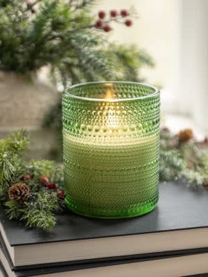Festive green dotted glass flameless candle featuring a warm flickering 3D flame, battery-operated with timer.