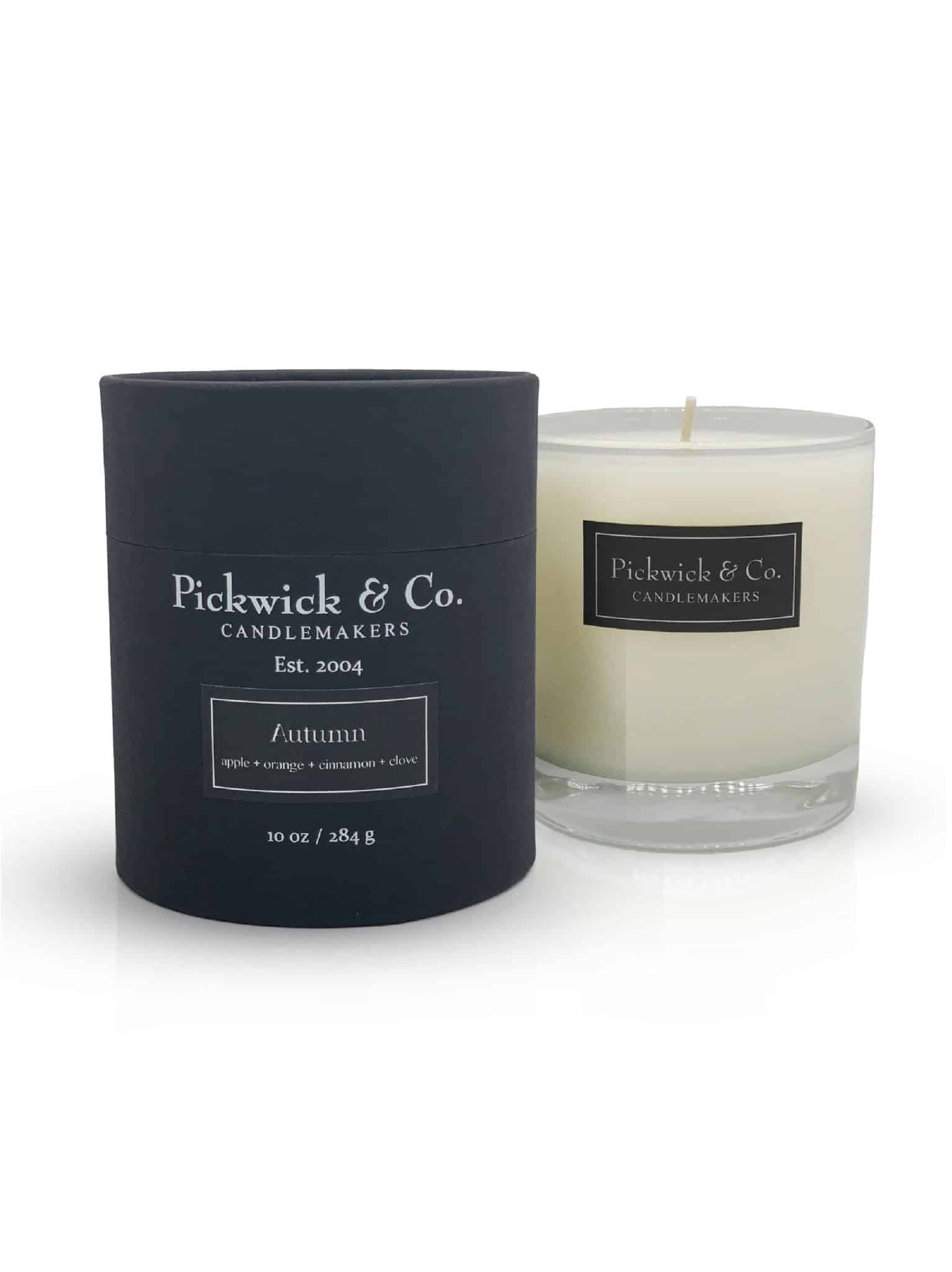 Autumn Pickwick Candle in glass vessel with black gift box, featuring baked apple, orange peel, cinnamon, clove, nutmeg, and vanilla fragrance.