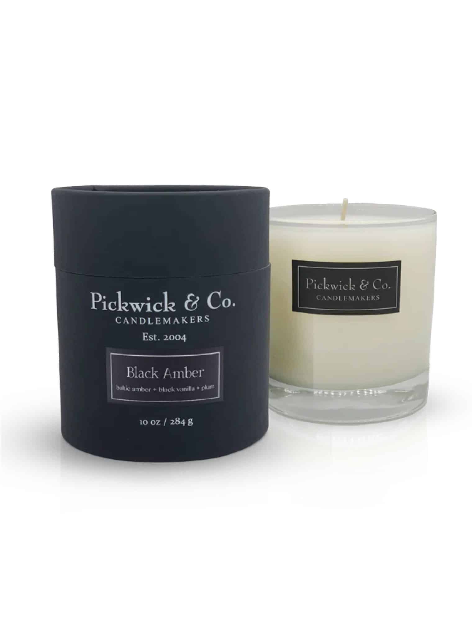Black Amber Pickwick Candle with black box and glass vessel, 10 oz soy candle in Baltic amber, tonka vanilla, and plum scent.
