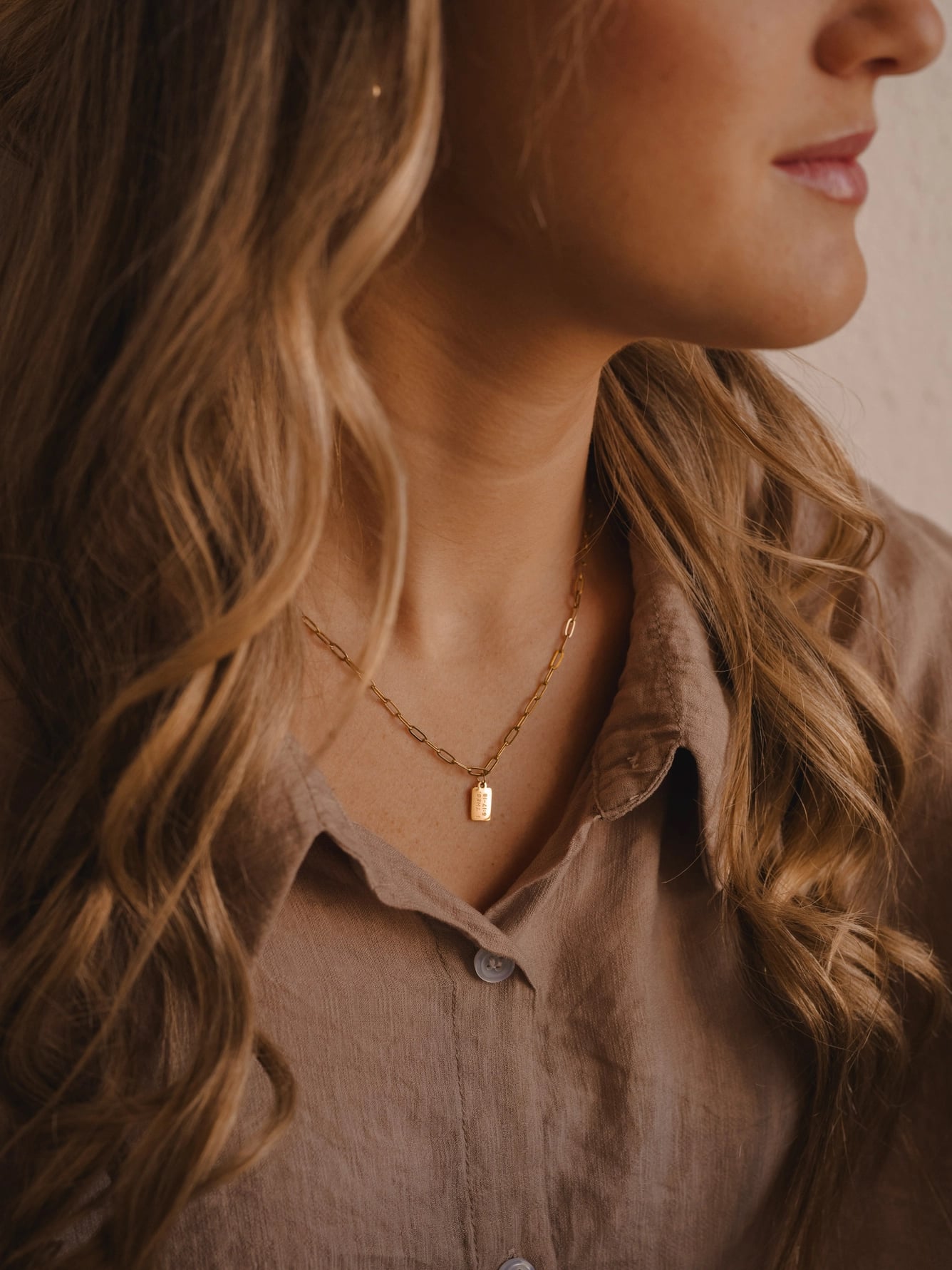Woman wearing Pray Big Mini Tag Necklace with gold mini tag charm