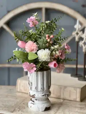 Pink Cottage Blooms Bush styled in a distressed white vase with mixed greenery and pink flowers