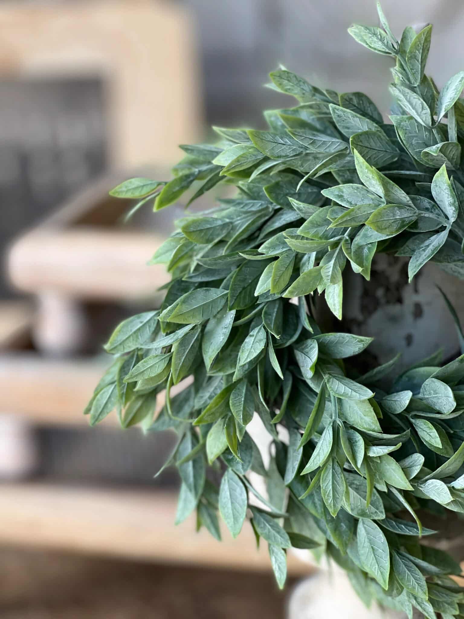 Powdered Lush Greenery Candle Ring with layered spear-shaped leaves and soft green tones draping naturally for added texture