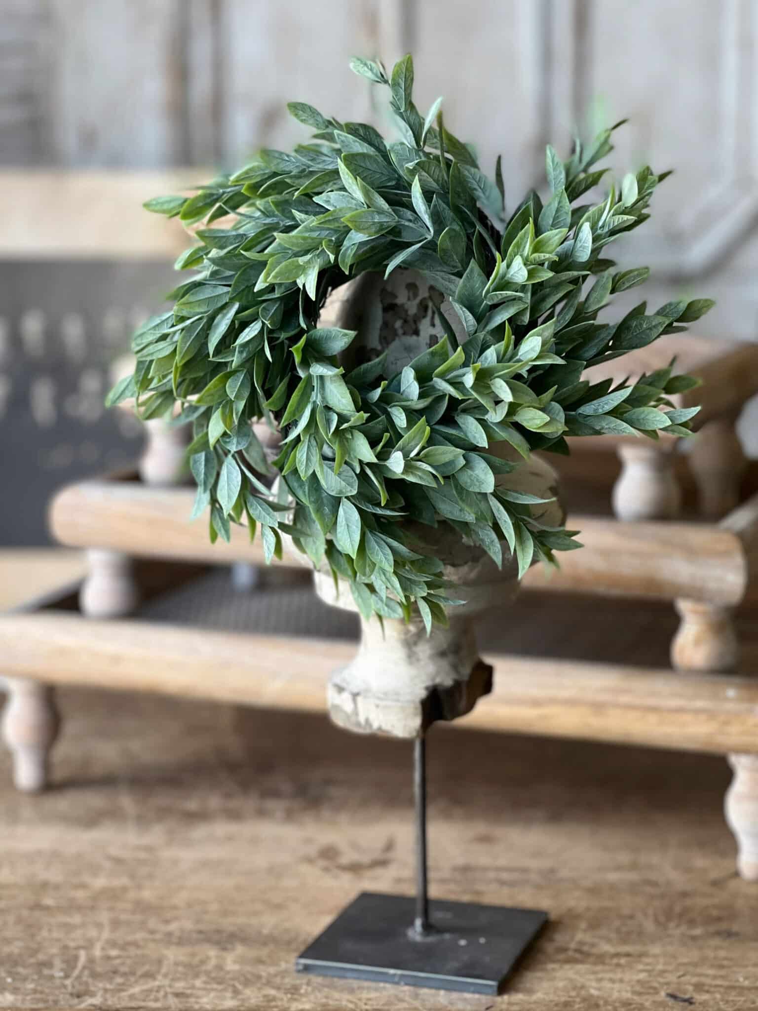 Powdered Lush Greenery Candle Ring styled on a metal stand showcasing full soft green foliage and realistic texture