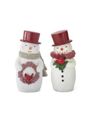 Two Snowman Figurines with red top hats shown together, one holding a red berry wreath with a cardinal and the other holding a cardinal with greenery. Glittered finish and textured scarves, 5 inches tall.