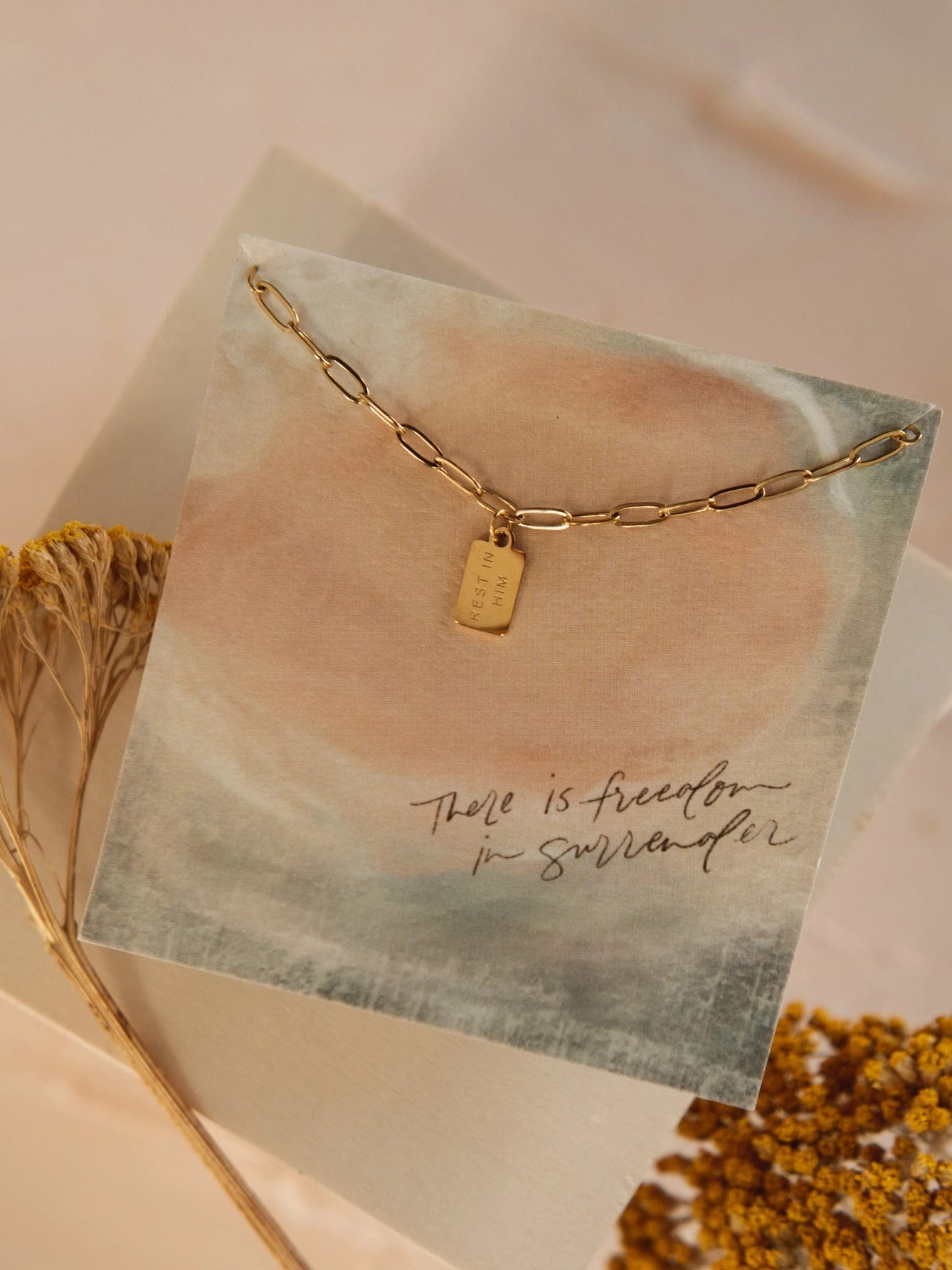be-made-hays-ks-rest-in-him-mini-tag-necklace-2 ose-up of Rest in Him Mini Tag Necklace with gold tag and chain