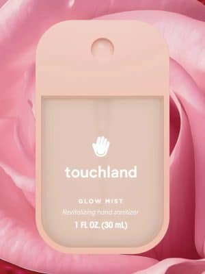 Rosewater Glow Mist Hand Sanitizer Spray on pink rose petals.