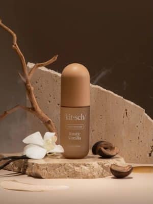 Rustic Vanilla Hair Perfume bottle styled with vanilla bean, white orchid, and cedarwood