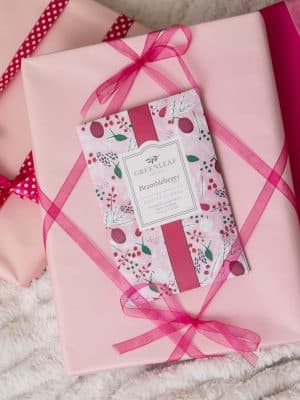 Greenleaf Brambleberry Scented Sachet Packet displayed on pink wrapped gift boxes with ribbon.