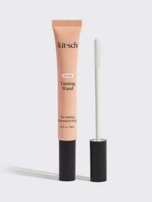 Close-up of clear hair styling taming wand with lightweight gel formula in a beige tube.