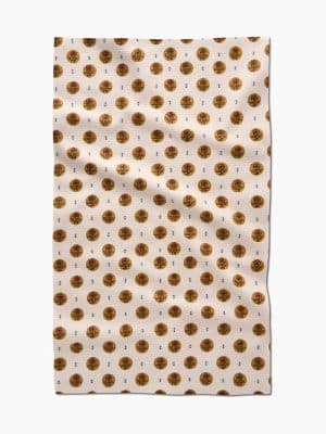 Flat-lay of the Artisanal Floral Cream Geometry Towel showing full pattern of gold circles with floral outlines on a cream microfiber fabric.