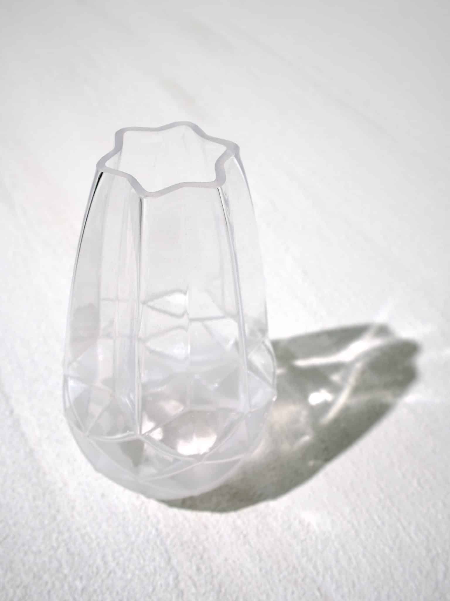 Modern frosted glass vase with faceted sides and a clover-shaped rim.