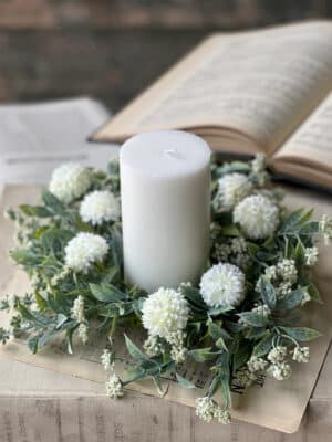 White Garden Pom Candle Ring styled around a white pillar candle for a soft centerpiece look