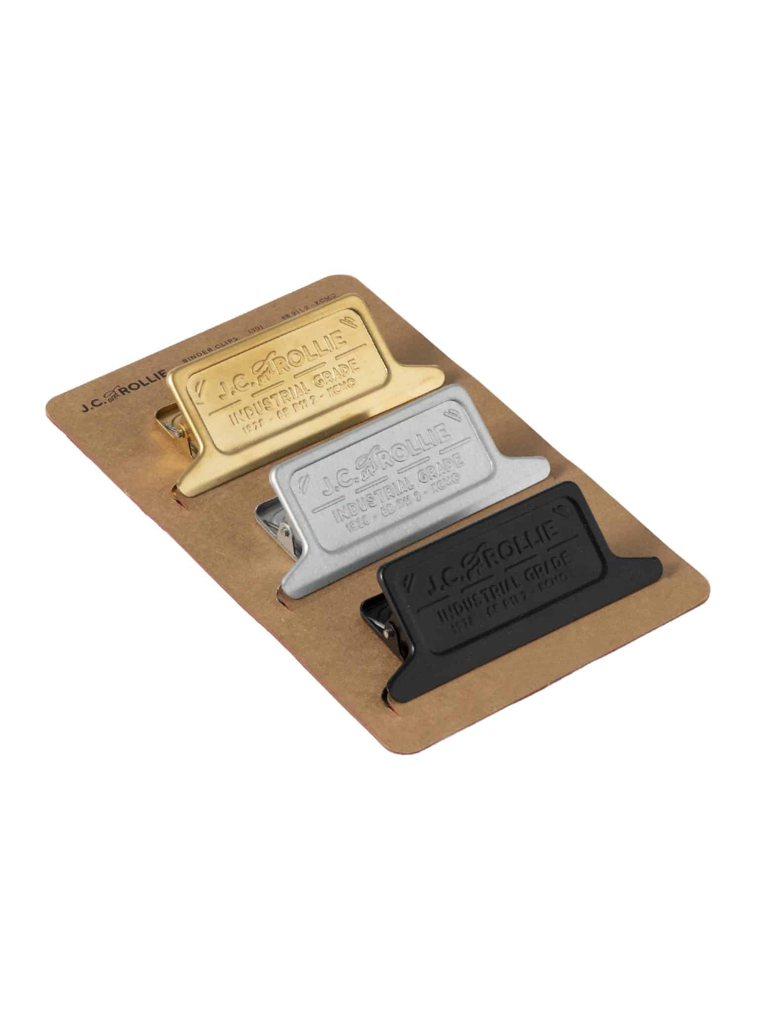 Angled view of binder clip set showing metallic finishes on a kraft paper backing