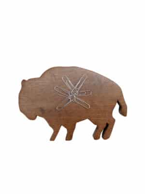 Wooden buffalo magnetic paperclip holder with silver paperclips clustered on its back, isolated on a white background.