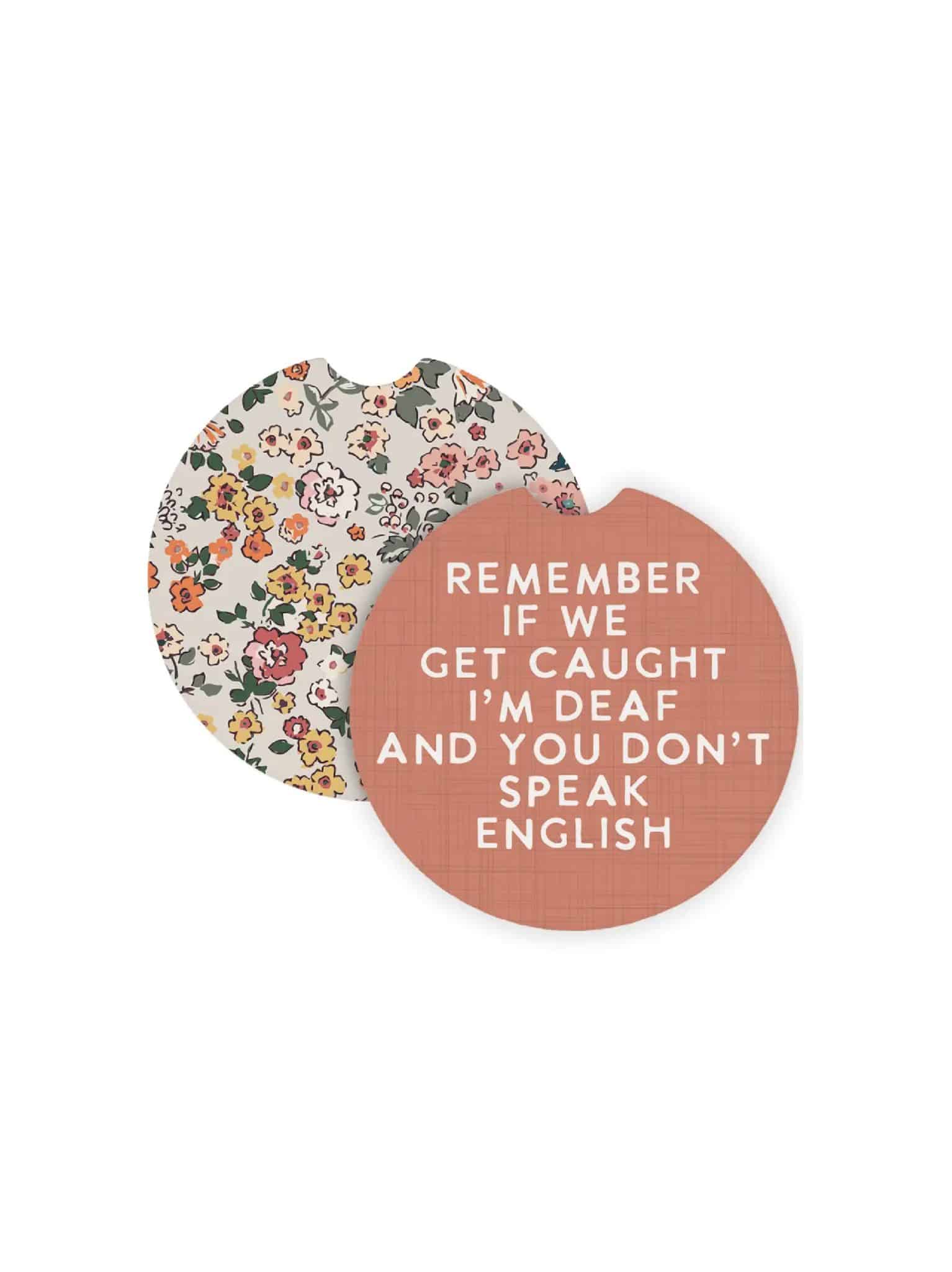 be-made-hays-ks-if-we-get-caught-car-coasters Round ceramic car coasters featuring a floral pattern on one side and the funny quote “Remember if we get caught I’m deaf and you don’t speak English” on the other.