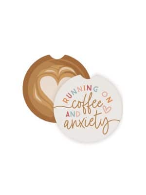 Round ceramic car coasters with a latte art design and the phrase โRunning on Coffee and Anxiety,โ made to fit standard car cup holders.