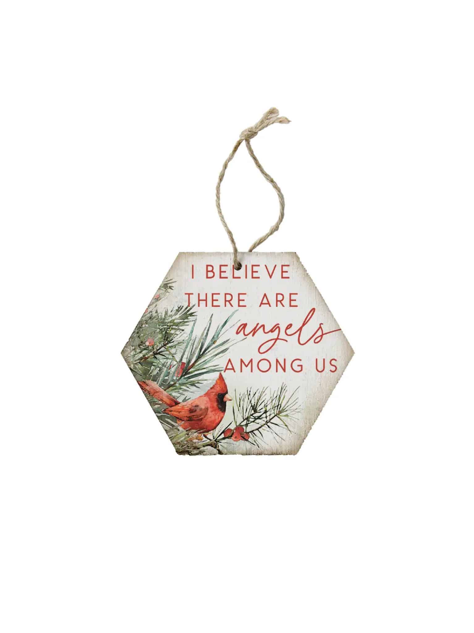 Hexagon wooden ornament with a red cardinal and the phrase “I believe there are angels among us,” hanging by twine.