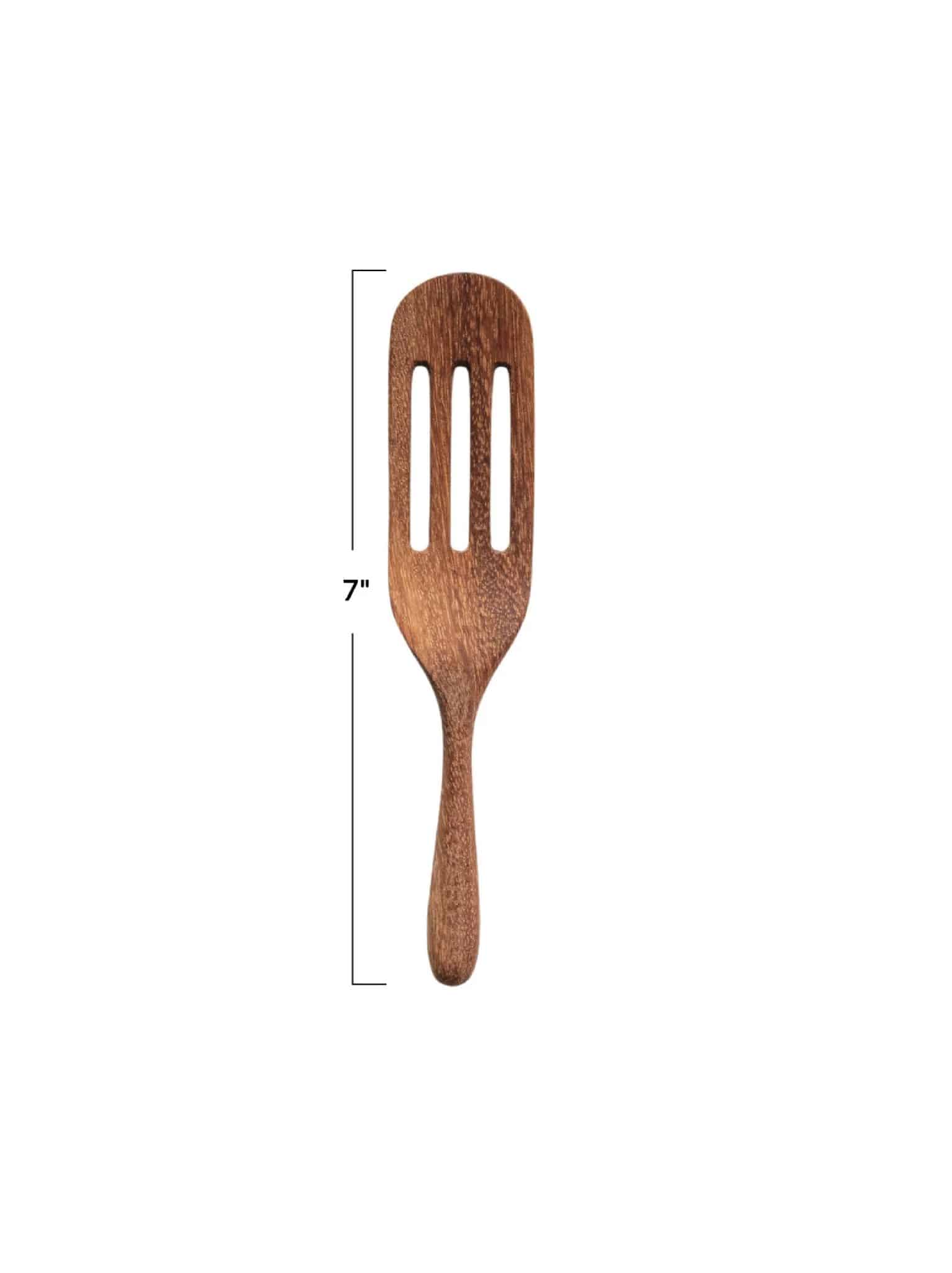 be-made-hays-ks-carved-natural-wood-spatula Single carved natural wood spatula with three slots, shown vertically with a 7-inch measurement guide on a white background.
