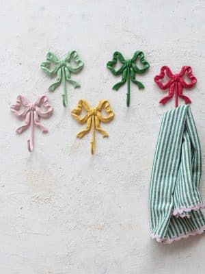 Cast Iron Bow Wall Hooks in assorted colors displayed on a textured wall.