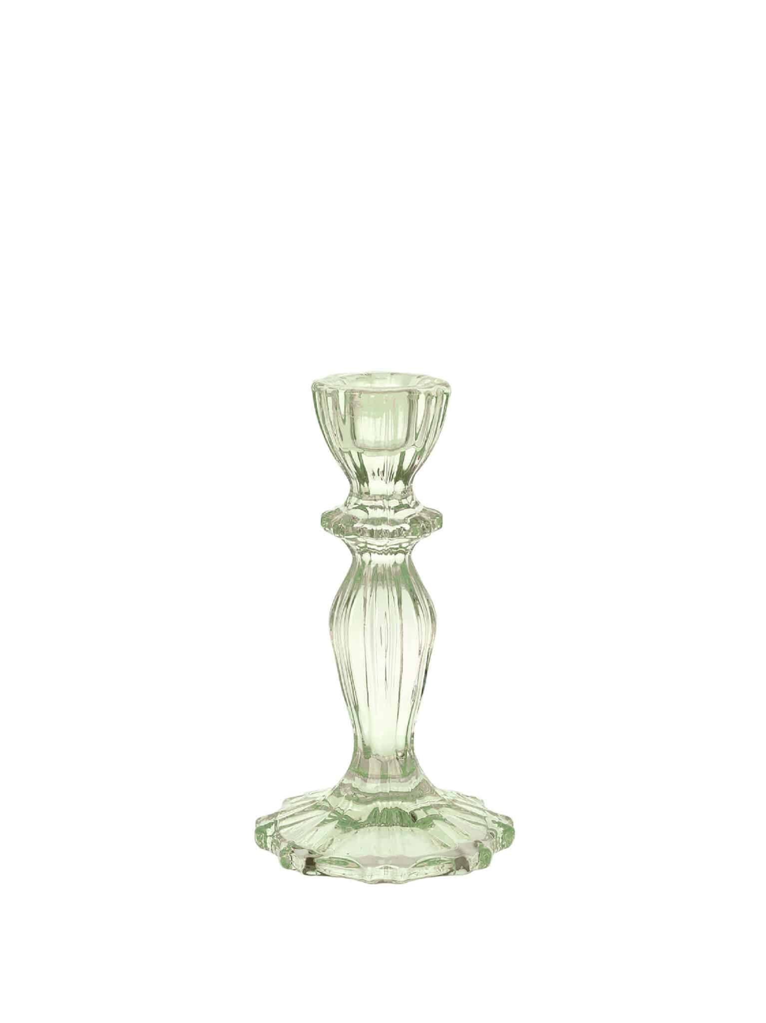 Green faceted glass taper candle holder on a white background with a vintage-inspired silhouette.