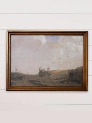 English landscape framed wall art featuring soft hills and trees in muted tones, displayed in an antique gold wood frame.