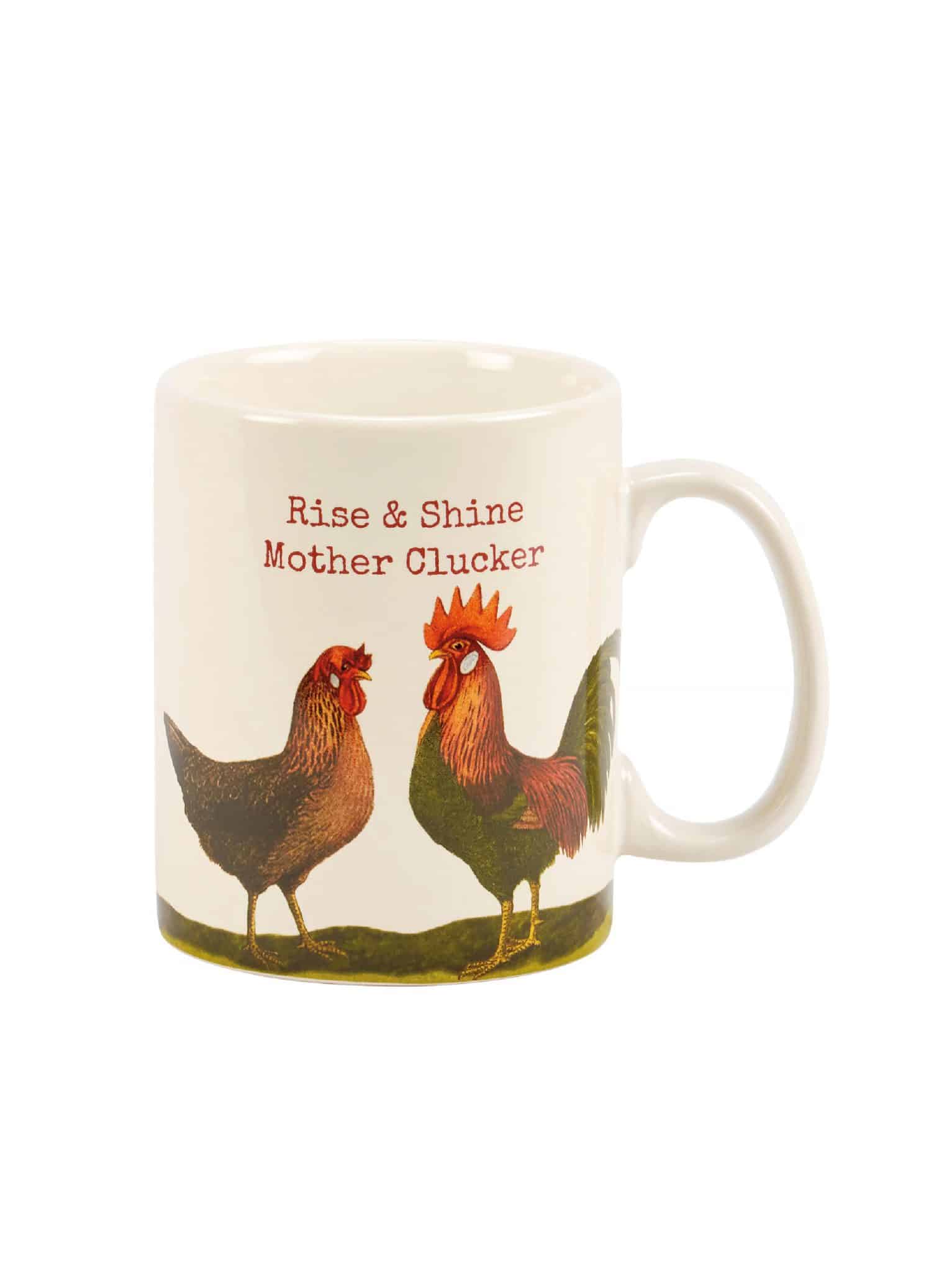 White stoneware mug with rooster and hen design and phrase “Rise & Shine Mother Clucker.”